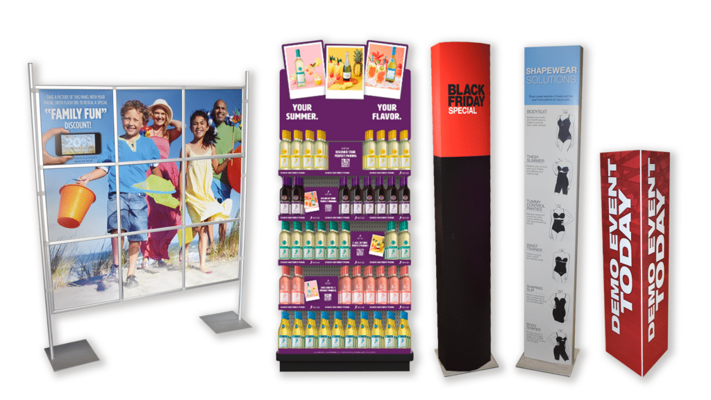 The image shows a variety of promotional display stands with colorful graphics, advertising family discounts, seasonal products, a Black Friday sale, and shapewear solutions.